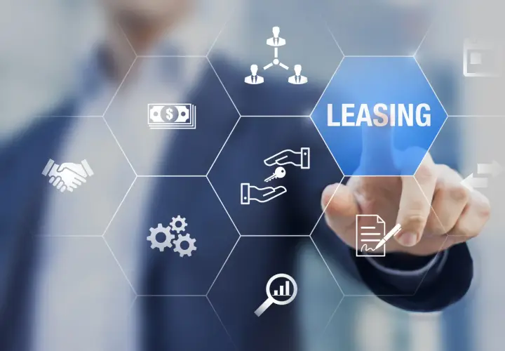 Dłoń dotyka ekranu z ikonami symbolizującymi leasing, pieniądze, klucze i umowę.
