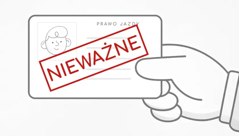 Dłoń trzyma prawo jazdy z czerwoną pieczątką "NIEWAŻNE".